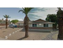 Cozy single story home with large front yard and mature palm trees at 3341 E Cochise Rd, Phoenix, AZ 85028
