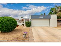 Charming home featuring a well-maintained yard and attached garage under a partly cloudy sky at 4024 W Griswold Rd, Phoenix, AZ 85051