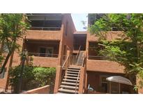 A charming exterior view shows the building's architecture with stairways and balconies at 4704 E Paradise Village N Pkwy # 211, Phoenix, AZ 85032