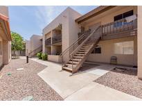 Attractive condo building with metal stairs, balconies, and a well-maintained exterior and walkway at 520 N Stapley Dr # 117, Mesa, AZ 85203