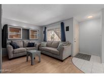 Cozy living room featuring comfortable sofas, a stylish coffee table, and lots of natural light at 520 N Stapley Dr # 117, Mesa, AZ 85203