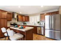 Well-lit kitchen features stainless steel appliances, a kitchen island, and white countertops at 524 W Fairway Dr # 10, Mesa, AZ 85201