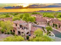 Stunning aerial view of luxury homes with beautiful desert landscaping and mountain views at sunset at 7751 E Golden Eagle Cir, Gold Canyon, AZ 85118