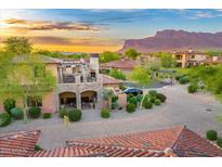 Charming home with stone accents, a private balcony, well manicured landscaping and mountain views at sunset at 7751 E Golden Eagle Cir, Gold Canyon, AZ 85118