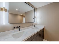 Modern bathroom featuring double vanity, quartz countertop, sleek black fixtures, and contemporary lighting for a spa-like feel at 8525 E Vía De Los Libros --, Scottsdale, AZ 85258