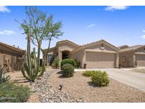 Charming single-story home with desert landscaping, cacti, and a two-car garage at 8934 E Calle Buena Vis, Scottsdale, AZ 85255