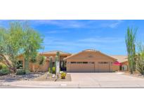 Warm Southwest home with a three car garage and mature desert landscaping at 9477 E Rosemonte Dr, Scottsdale, AZ 85255