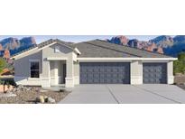Charming single-story home with a three-car garage and desert landscaping against a backdrop of majestic mountains at 12235 E Agave Ln, Florence, AZ 85132