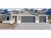 Charming single-story home boasting a three-car garage, neutral color palette, and meticulously maintained landscaping at 12247 E Agave Ln, Florence, AZ 85132