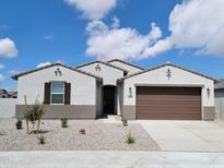 Beautiful single-story home with a two-car garage and meticulously landscaped front yard with gravel and shrubbery at 19152 N Bandin Dr, Maricopa, AZ 85138