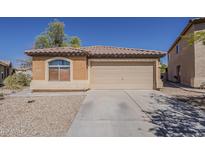 Charming single-story home featuring a two car garage, neutral paint, and a well-maintained front yard at 20761 N Herbert Ave, Maricopa, AZ 85138