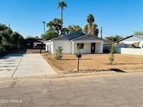 Charming single-story home with well-manicured lawn, palm trees, and a lovely entrance with fresh driveway at 2148 W Hayward Ave, Phoenix, AZ 85021