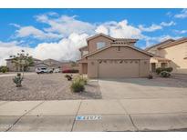 Two-story home featuring a neutral palette, large garage, and low-maintenance desert landscaping at 22672 W Solano Dr, Buckeye, AZ 85326