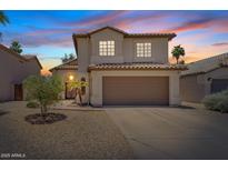 Charming two-story home with a well-maintained yard and attached two car garage, under a colorful sunset at 706 N El Dorado Dr, Gilbert, AZ 85233