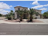 Inviting two-story home with desert landscaping, stone accents, and a driveway basketball hoop at 7419 S 25Th Dr, Phoenix, AZ 85041