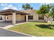 Charming single-story home with a covered carport and well-manicured front lawn at 7707 E Park View Dr, Mesa, AZ 85208