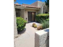 Inviting front entrance with desert landscaping, lush bushes, and a private courtyard at 7914 E Bonita Dr, Scottsdale, AZ 85250