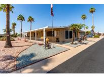 Charming home featuring a long porch, complemented by palm trees and xeriscaping for a low-maintenance yard at 8103 E Southern Ave # 119, Mesa, AZ 85209