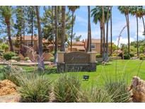 Beautifully landscaped community entrance with mature trees and attractive signage at 8787 E Mountain View Rd # 1100, Scottsdale, AZ 85258
