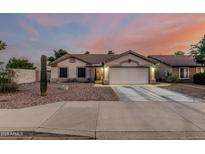 Charming single-story home featuring a well-maintained front yard and attached two-car garage at 11361 E Escondido Ave, Mesa, AZ 85208