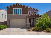 Charming two-story home with a two-car garage, craftsman architecture, and nicely landscaped front yard at 12041 W Fillmore St, Avondale, AZ 85323