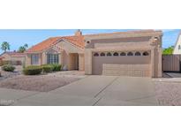 Charming single-story home featuring a well-manicured yard and attached two-car garage, set in a suburban neighborhood at 12730 N 90Th Way, Scottsdale, AZ 85260