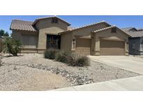 Charming single-story stucco home with tile roof, desert landscaping, and two-car garage at 12822 W Flower St, Avondale, AZ 85392