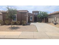 Charming single-story home featuring a well-kept yard and a spacious driveway for easy parking at 14841 W Desert Hills Dr, Surprise, AZ 85379