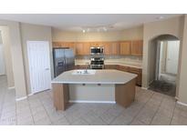 Open kitchen with a large island, stainless steel appliances, and ample counter space at 14841 W Desert Hills Dr, Surprise, AZ 85379