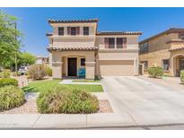 Inviting two-story home with a well-manicured lawn and a charming blue porch bench, perfect for enjoying sunny days at 18542 W Valerie Dr, Surprise, AZ 85374