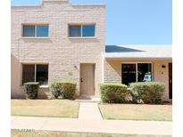 Charming two-story home with a well-maintained lawn and inviting front entrance at 225 N Standage -- # 45, Mesa, AZ 85201