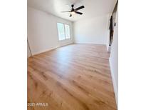 Bright living room with a ceiling fan, window, and light wood flooring at 225 N Standage -- # 45, Mesa, AZ 85201