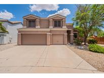 Charming two-story home with a three car garage and well-maintained front yard at 33055 N Madison Way Dr, San Tan Valley, AZ 85144