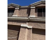 View of a two-story home featuring stucco walls, two-car garage, and windows at 33055 N Madison Way Dr, San Tan Valley, AZ 85144
