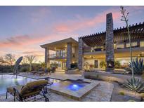 Stunning backyard with a pool, spa, fireplace, outdoor kitchen and covered patio, perfect for entertaining and relaxation at 36389 N 105Th Pl, Scottsdale, AZ 85262