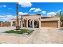 Charming single-story home featuring a stucco exterior, arched entry, and a well-maintained front yard at 858 W Knowles Cir, Mesa, AZ 85210