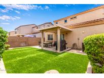 Enjoy the outdoors with a covered patio and artificial turf, perfect for entertaining at 8788 W Wood Dr, Peoria, AZ 85381