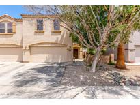 Inviting two-story home featuring an attached two-car garage and desert landscaping at 8788 W Wood Dr, Peoria, AZ 85381