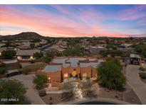 Stunning home at sunset with desert landscaping and mountain views at 9435 E Hobart Cir, Mesa, AZ 85207