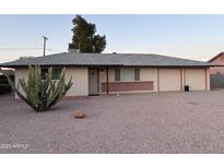 Charming single story home featuring a two car garage and desert landscaping at 1019 E Granada Ave, Apache Junction, AZ 85119