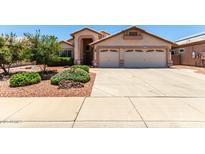 Charming single-story home featuring a spacious driveway, desert landscaping, and a two-car garage at 11023 W Chino Dr, Peoria, AZ 85373