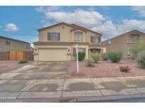 Two-story home with a two car garage, desert landscaping, and neutral color palette at 2194 N Magdelena Pl, Casa Grande, AZ 85122