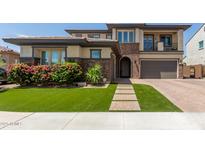 Beautiful two-story home with a well-manicured lawn, brick accents, and inviting entryway at 3408 E Daley Ln, Phoenix, AZ 85050