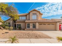 Stunning two-story home featuring a well-manicured front yard, desert landscaping and tile roof at 3641 E Park Ave, Phoenix, AZ 85044