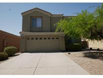 Two-story home featuring an attached two-car garage and easy-care desert landscaping for water conservation at 43241 W Kristal Ln, Maricopa, AZ 85138