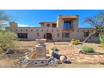 Custom home with brick exterior, fountain, landscaped yard, and desert surroundings at 5141 E Rancho Tierra Dr, Cave Creek, AZ 85331