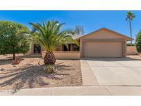 Charming single-story home featuring desert landscaping and an attached two-car garage at 9857 W Tonto Ln, Peoria, AZ 85382