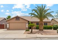 Charming single-story home showcasing desert landscaping and a neutral color palette at 10341 E Dragoon Ave, Mesa, AZ 85208
