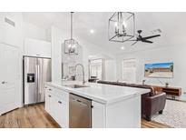 Bright kitchen featuring white cabinets, stainless steel appliances, and modern lighting fixtures at 17827 N 51St Way, Scottsdale, AZ 85254