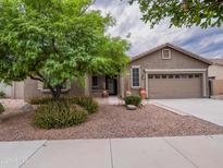 Charming single-story home featuring a well-maintained landscape and a two car garage at 22986 S 208Th St, Queen Creek, AZ 85142